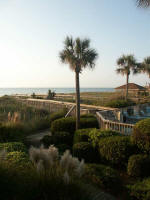 Pool chairs and boardwalk leading out to the beach path.