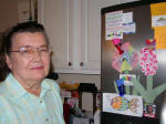 Carol admires her granddaughter's refrigerator art.