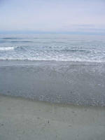 Calm afternoon surf at low tide.