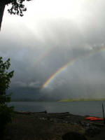 Double rainbow: a second rainbow on the outside of the first, brighter rainbow, from raindrops higher than those causing the "primary rainbow", and specialthey internally reflect the incoming sunlight twice rather than just once.