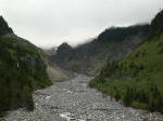 View from Glacier Bridge up toward the Nisqually Glacier. Valleys that radiate from the mountain are of glacial origin, broad at their lower ends, but approaching the mountain becoming more narrow and their sides more precipitous.