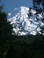 Mount Rainier's current summit, Columbia Crest, lies on the rim of a recent lava cone, the upper portion likely removed by explosions and landslides, a reminder of earth's power.