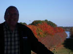 Joe from the top of the NATO Tower with an airplane approaching the runway just past the NATO vista.