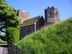 The Roman Pharos (lighthouse) ruins rise adjacent to the Church of St. Mary-in-Castro, circa 1000, the finest late-Saxon building standing in southeast England.